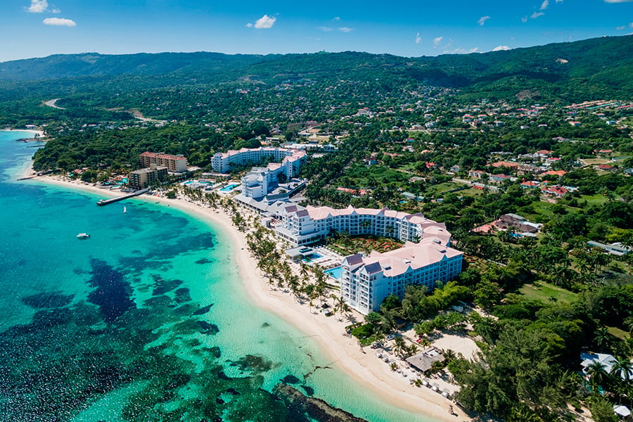 Aerial view of Hotel RIU Ocho Rios, with beachfront resort buildings and swimming pools